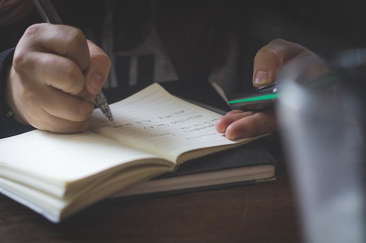 person, writing, beige, lined, paper, notebook, pen