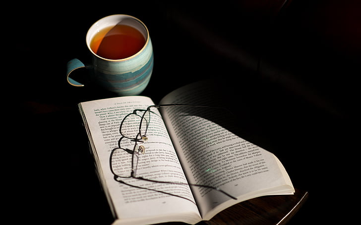 book, cup, drink, eyeglasses, eyewear, mug, page