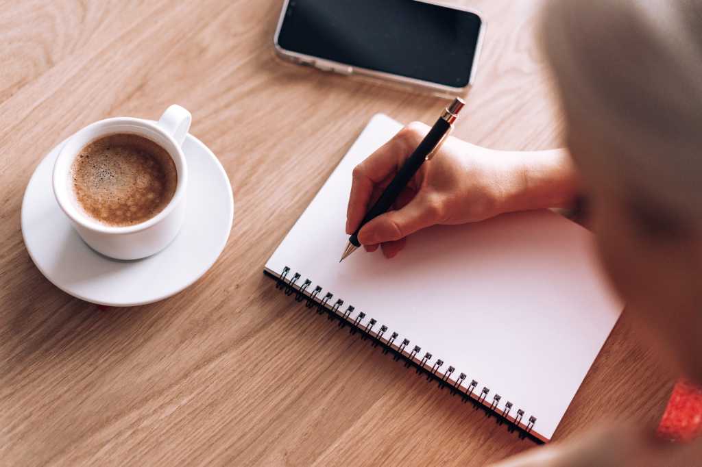 Book Author Woman Writing a New Story in a Diary Free Stock Photo